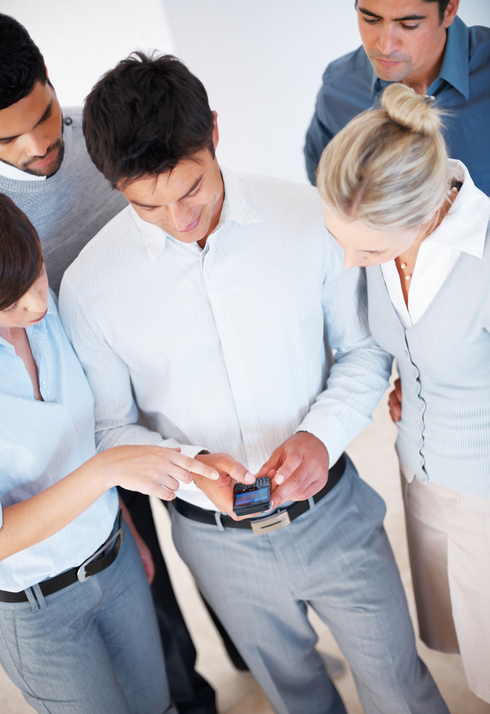 Social media people gathering around a phone