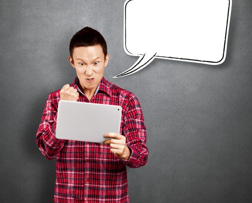 angry man with blank speech bubble holding tablet computer