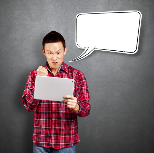 angry man with blank speech bubble holding tablet computer