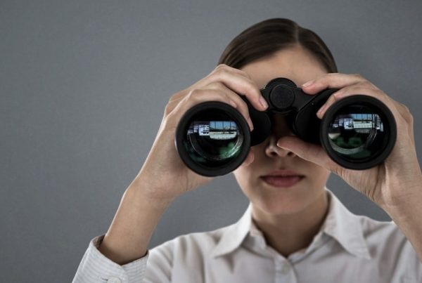 woman looking through binoculars