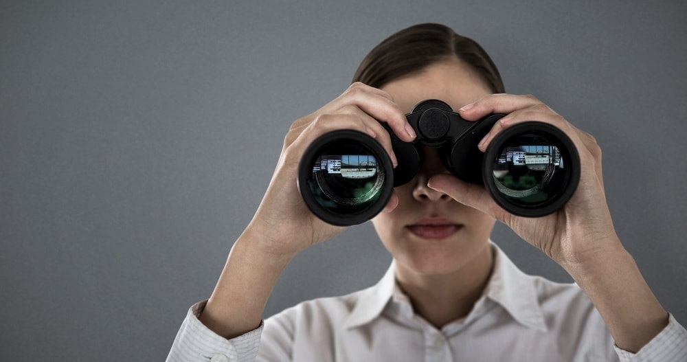 woman looking through binoculars