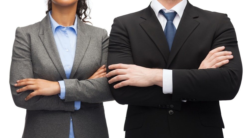 businesswoman and businessman with arms crossed